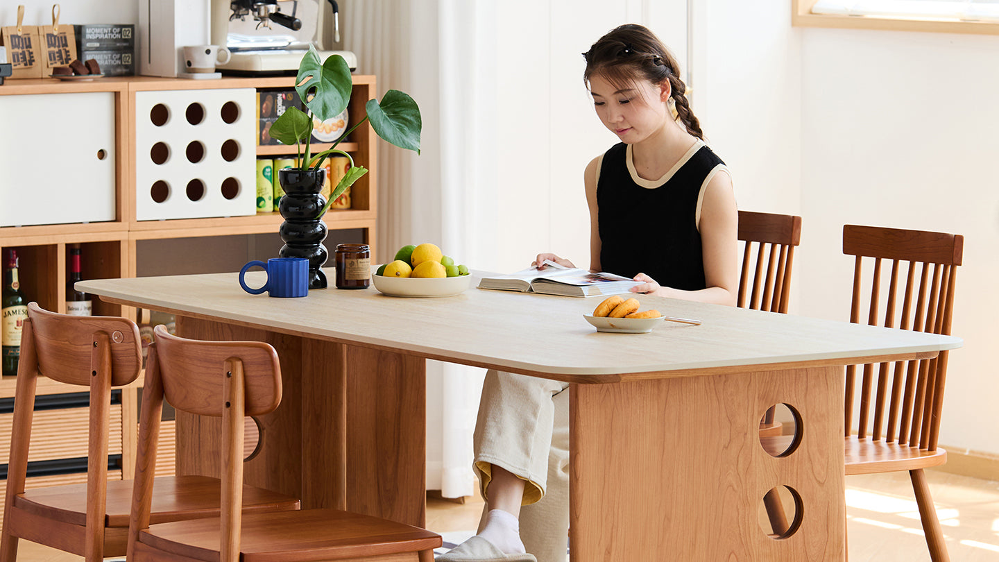 Modern wooden dining table with a minimalist design, complemented by matching chairs, creating a warm and inviting space for dining and relaxation.
