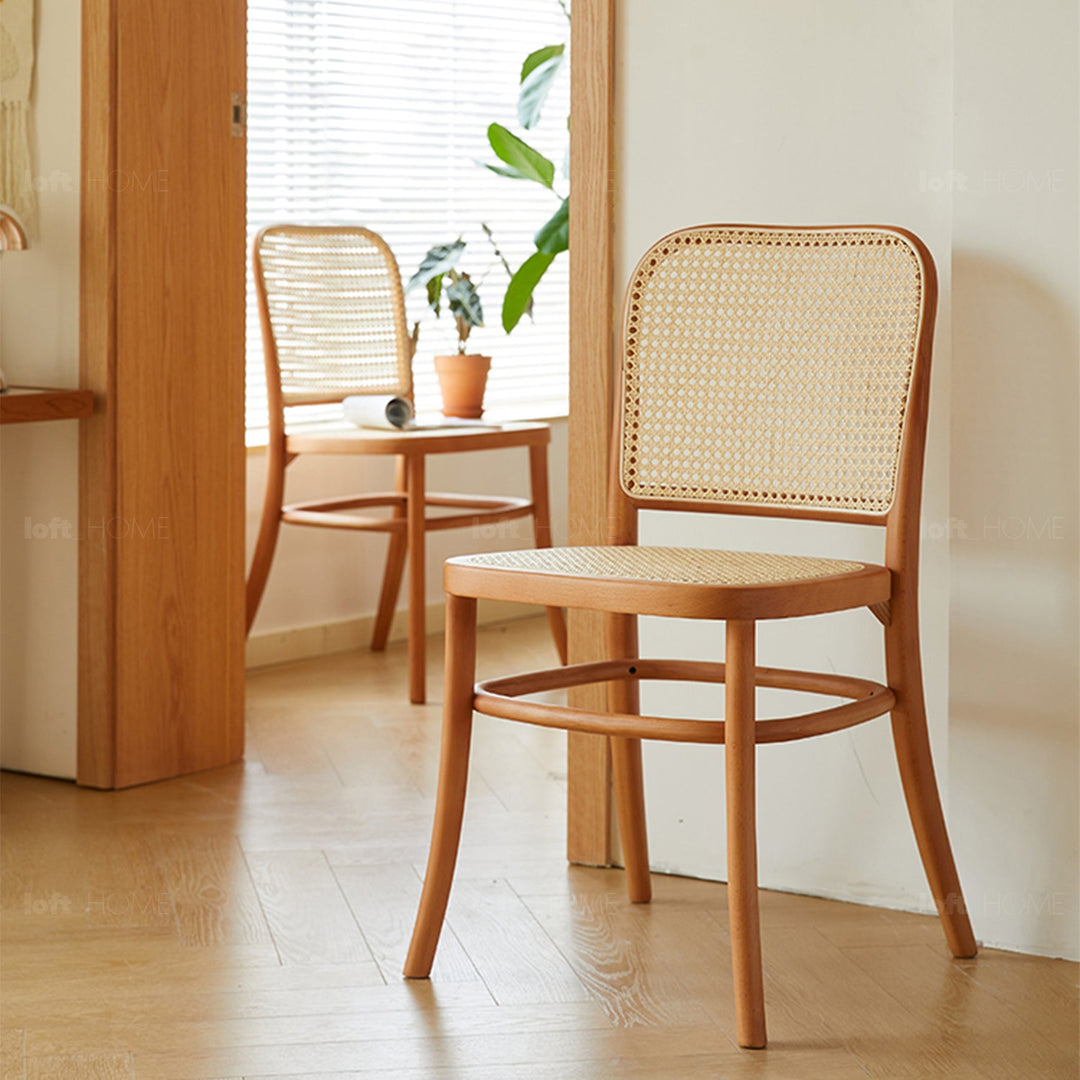 Natural wood dining chair with rattan backrest and seat, adding a warm and airy touch to modern or Scandinavian-inspired dining spaces.