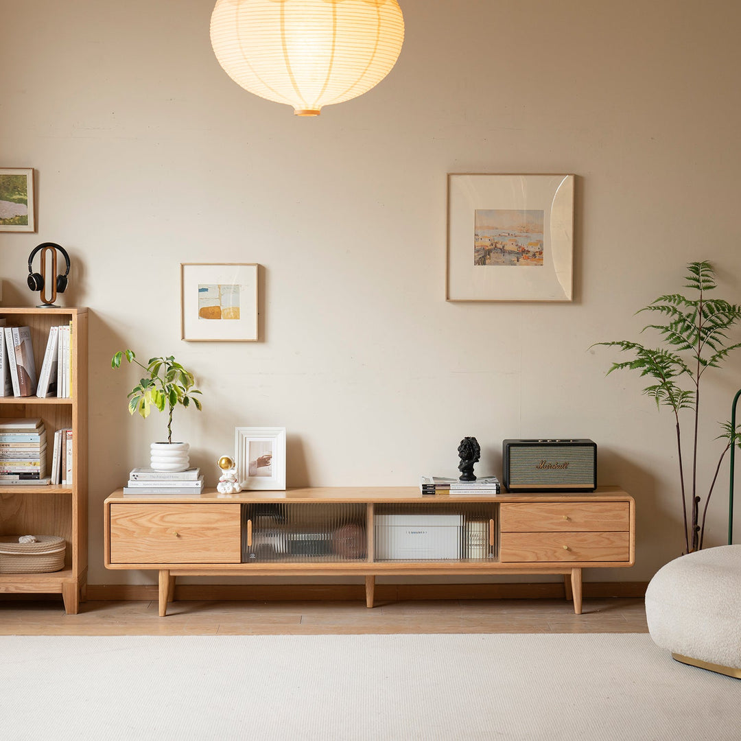 Scandinavian-style TV console crafted from natural wood with sleek legs and sliding glass doors, perfect for adding warmth and functionality to modern living spaces.