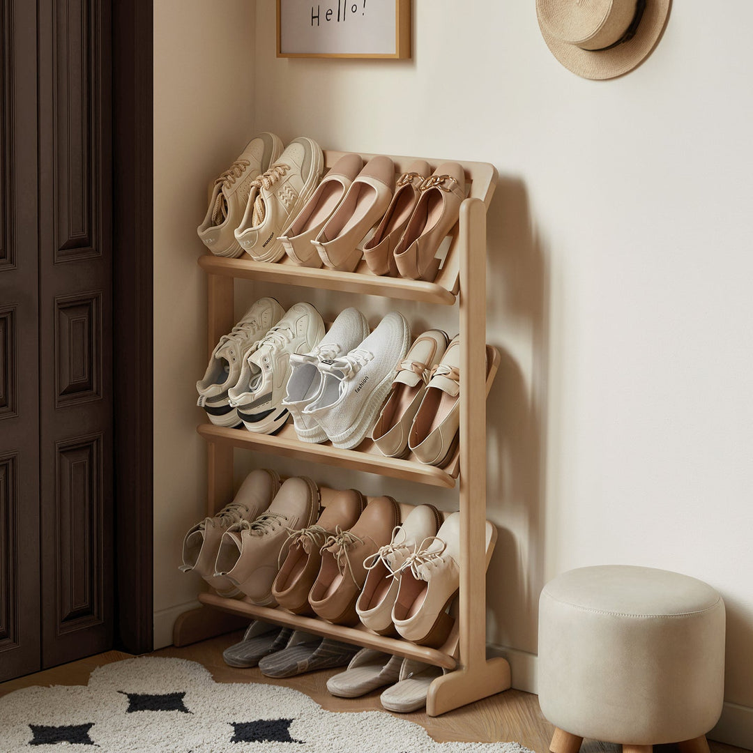 Wooden shoe rack with three tiers, neatly organizing various shoes in a compact design, perfect for decluttering entryways and creating a welcoming space.